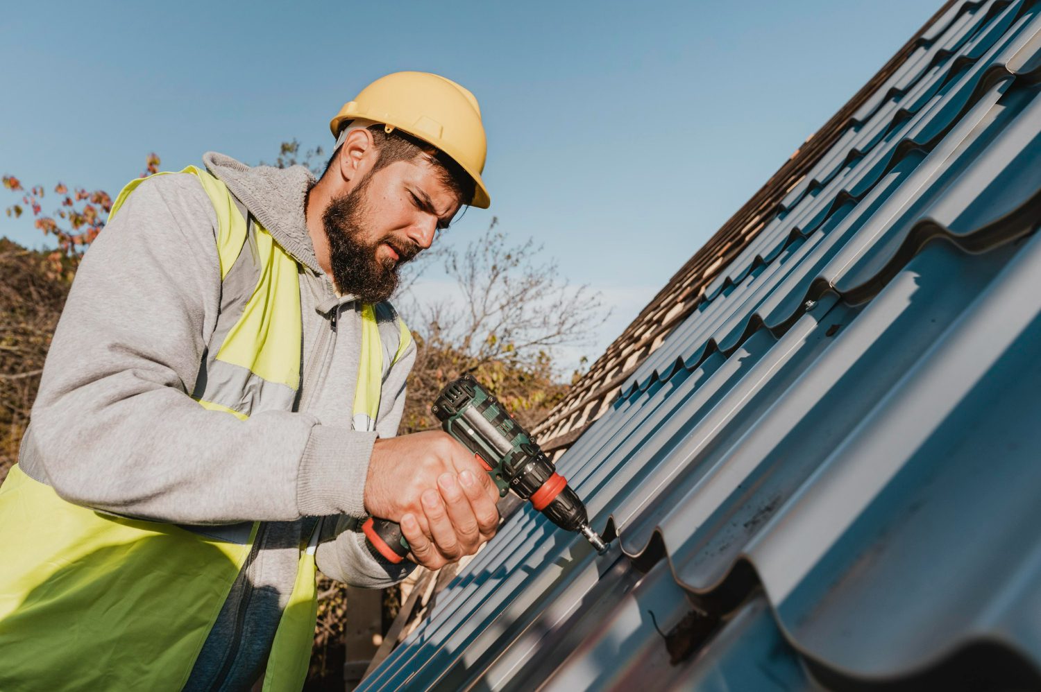 sideways-man-working-roof-with-drill roof replacement
