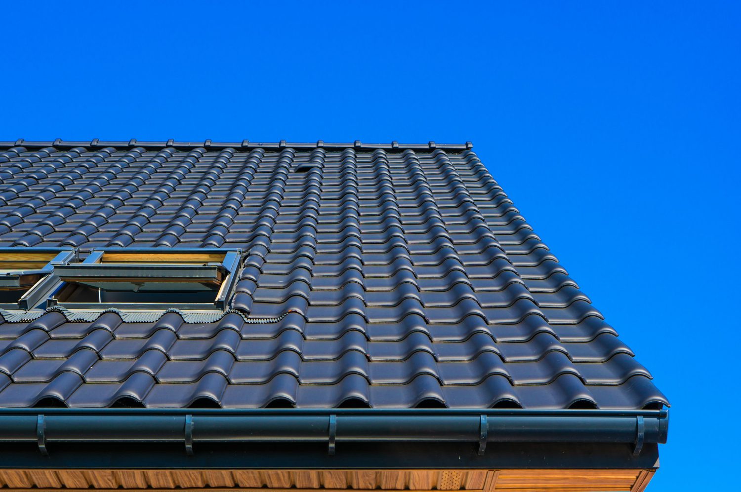 vertical-low-angle-closeup-shot-black-roof-building metalic roofing over house
